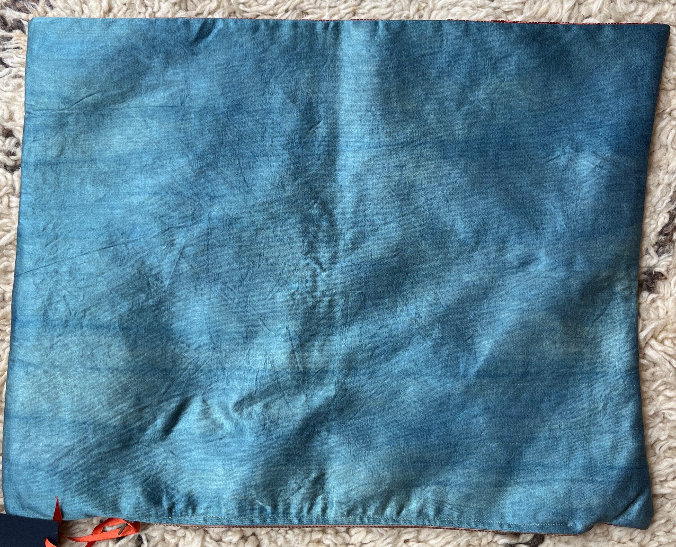 Rectangular Ottoman-style Suzani cushion with a central rosette, flowing saz leaves, and a tulip border.