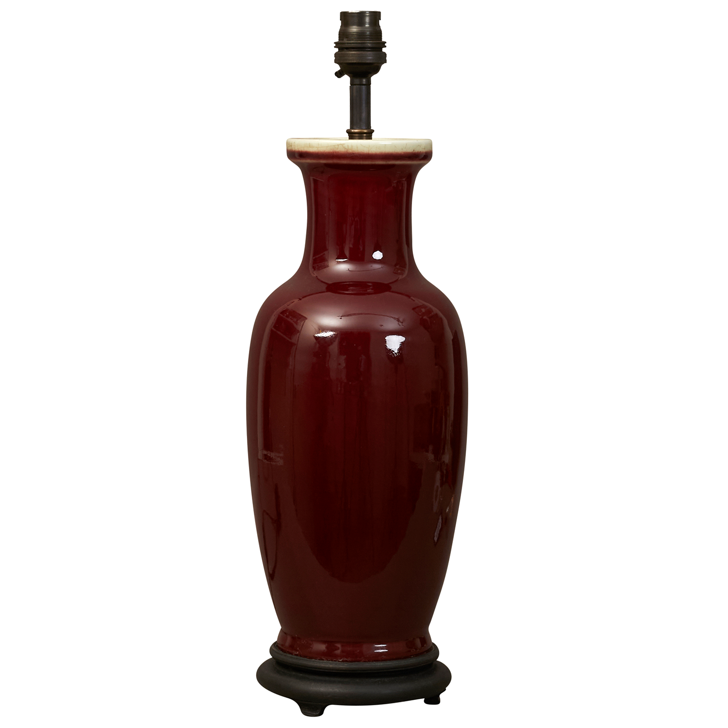 A Sang de boeuf glazed ceramic table lamp on ebonised stand