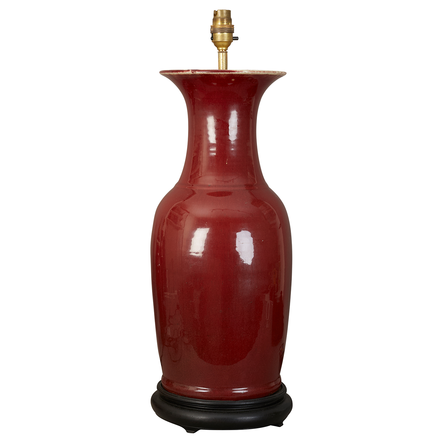 A large Sang de boeuf glazed ceramic table lamp on ebonised stand