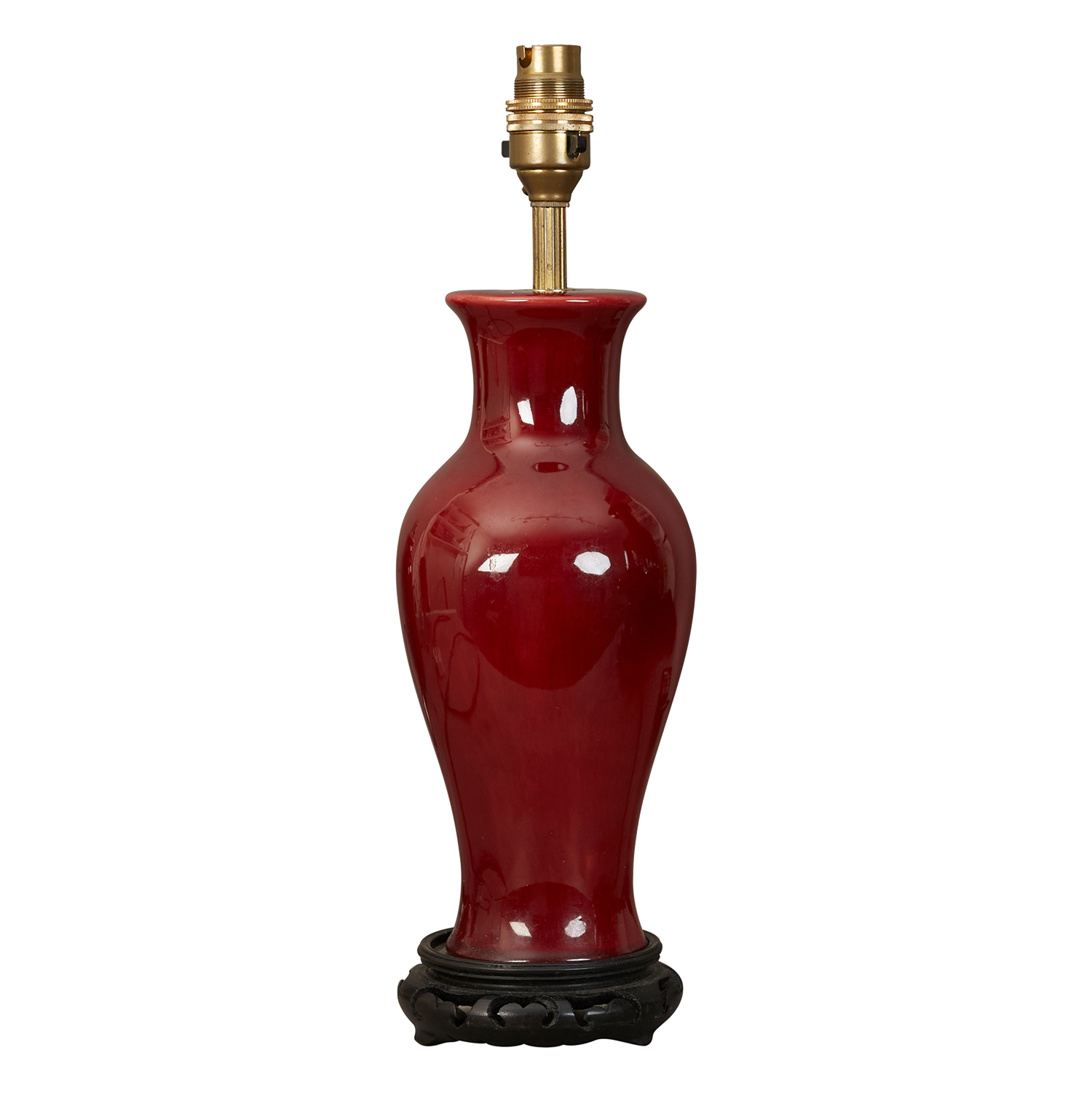 A small Sang de boeuf glazed ceramic table lamp on ebonised stand