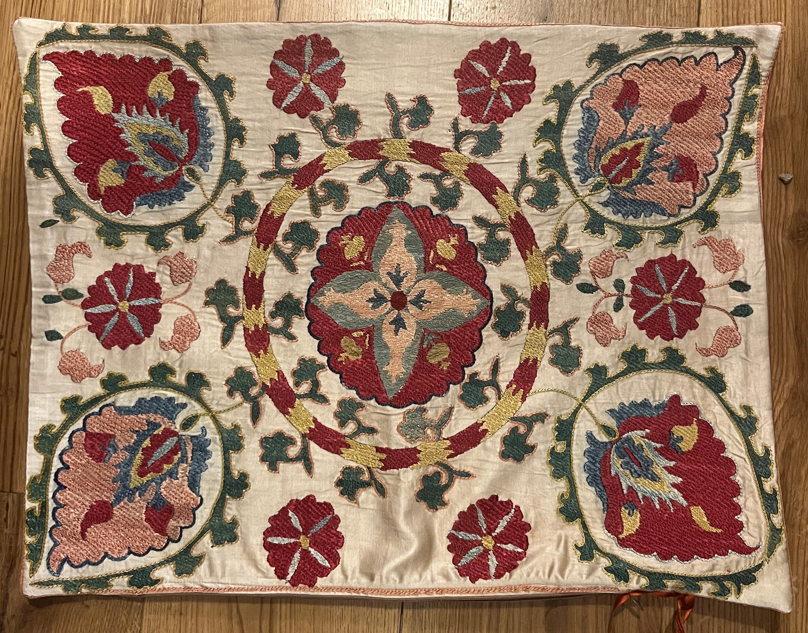 Rectangular silk suzani cushion with multicoloured Ottoman design on cream ground