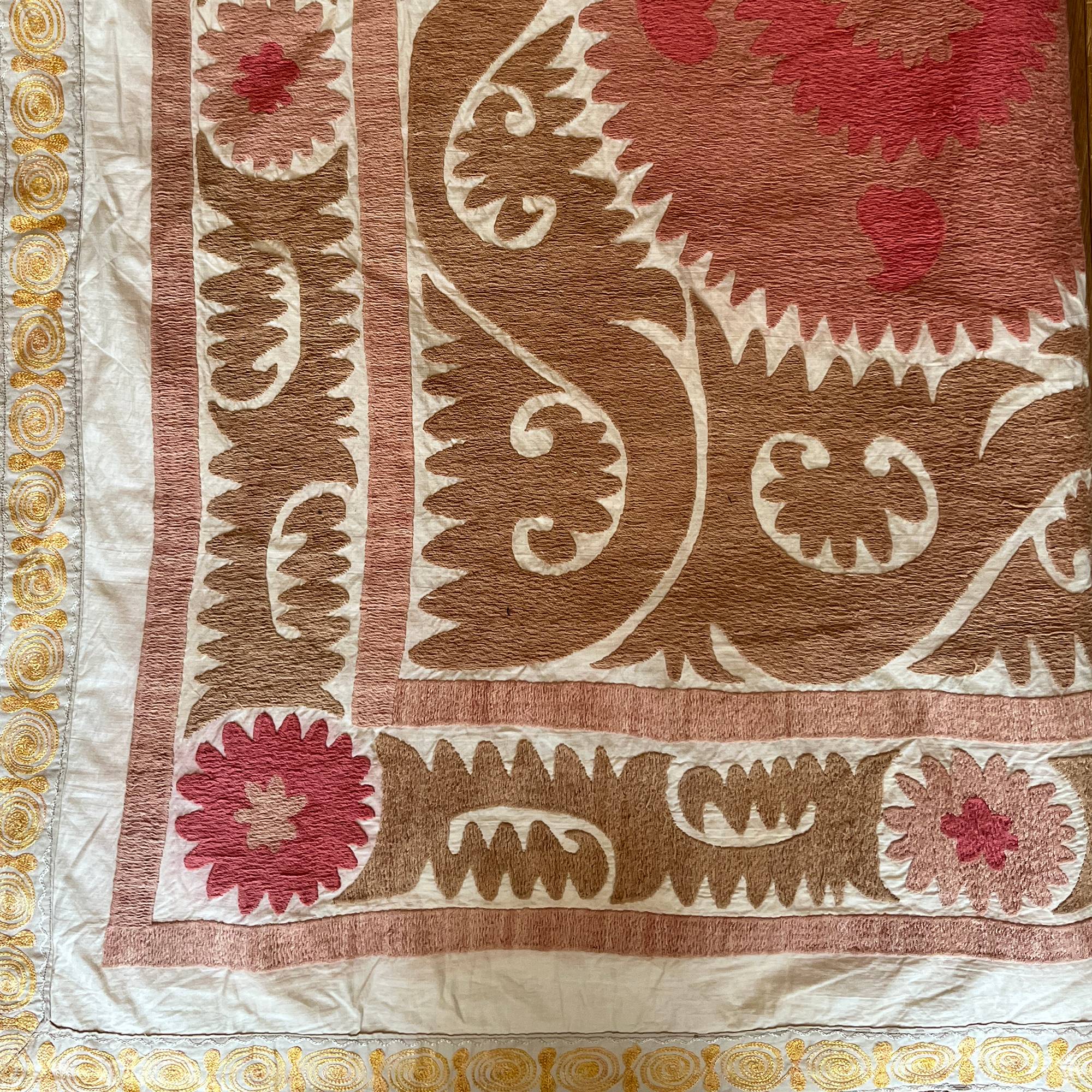 Large rectangular cotton Suzani camel and dusky pink hanging/bedspread with gold embroidered border, Uzbekistan circa 2000