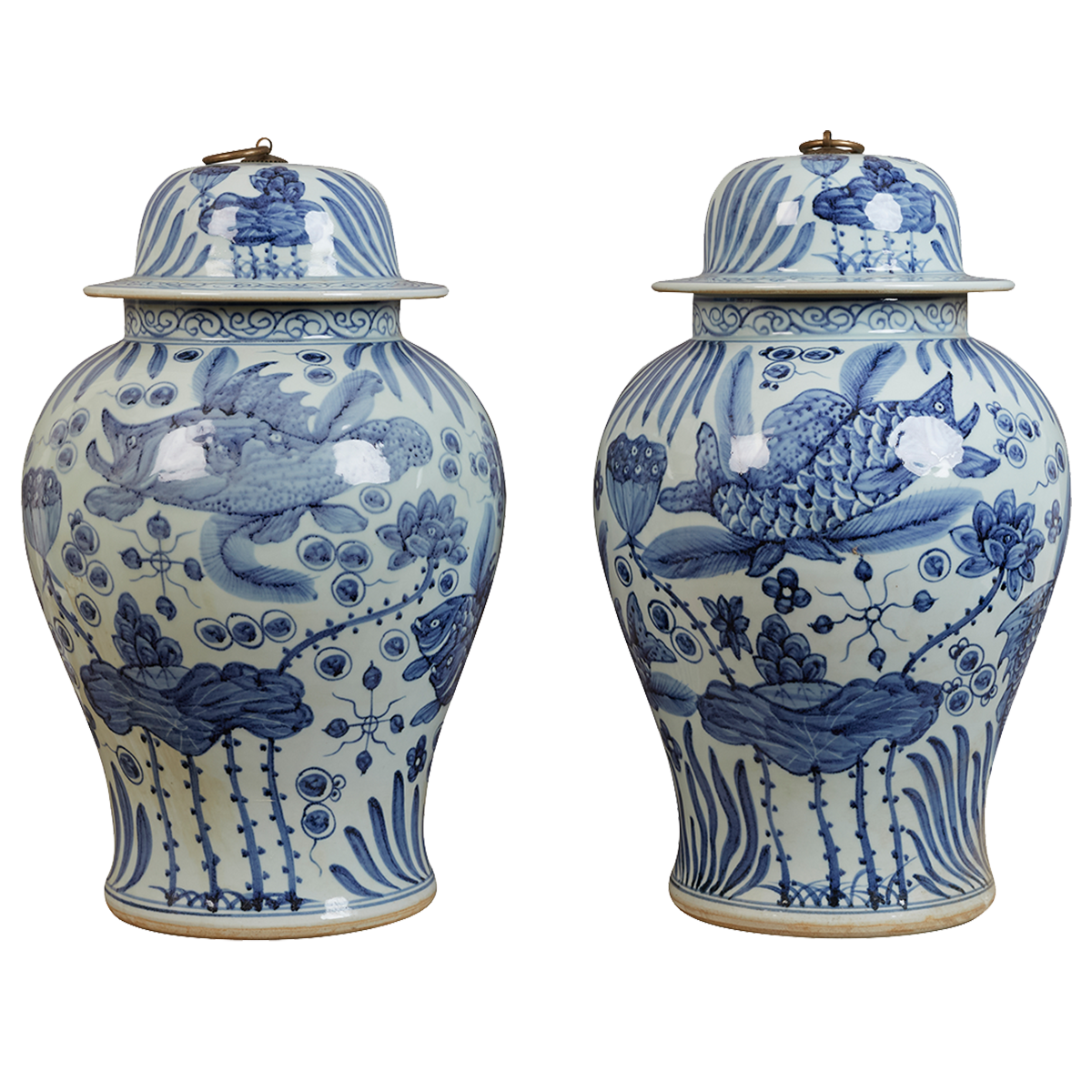 A pair of contemporary blue and white Chinese-style lidded jars, decorated with carp