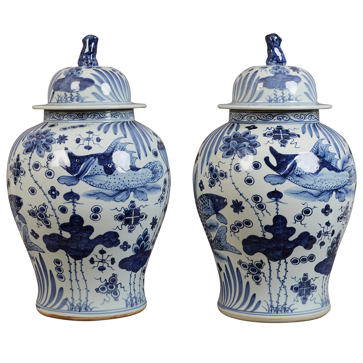 A pair of contemporary blue and white Chinesse jars, decorated with playful fish swimming among stylised aquatic plants and floral motifs