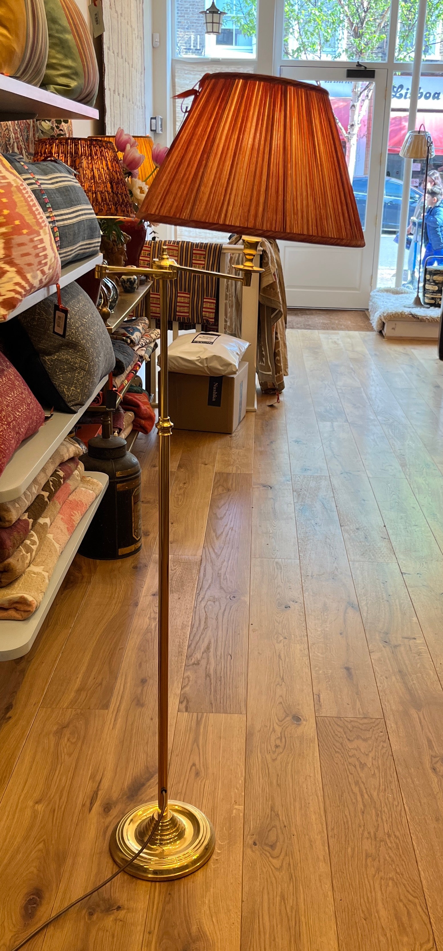 A brass swivel floor standing lamp