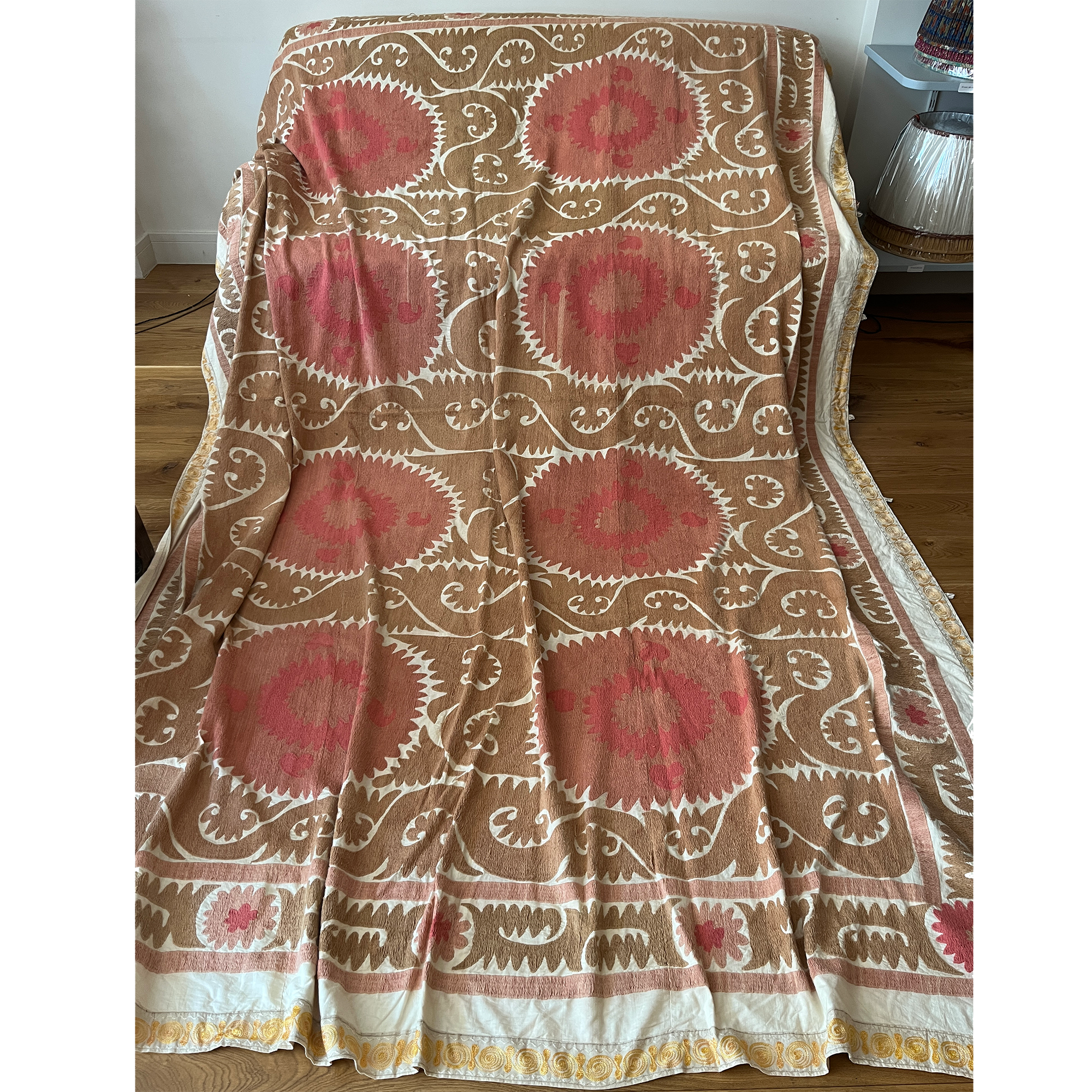 Large rectangular cotton Suzani camel and dusky pink hanging/bedspread with gold embroidered border, Uzbekistan circa 2000